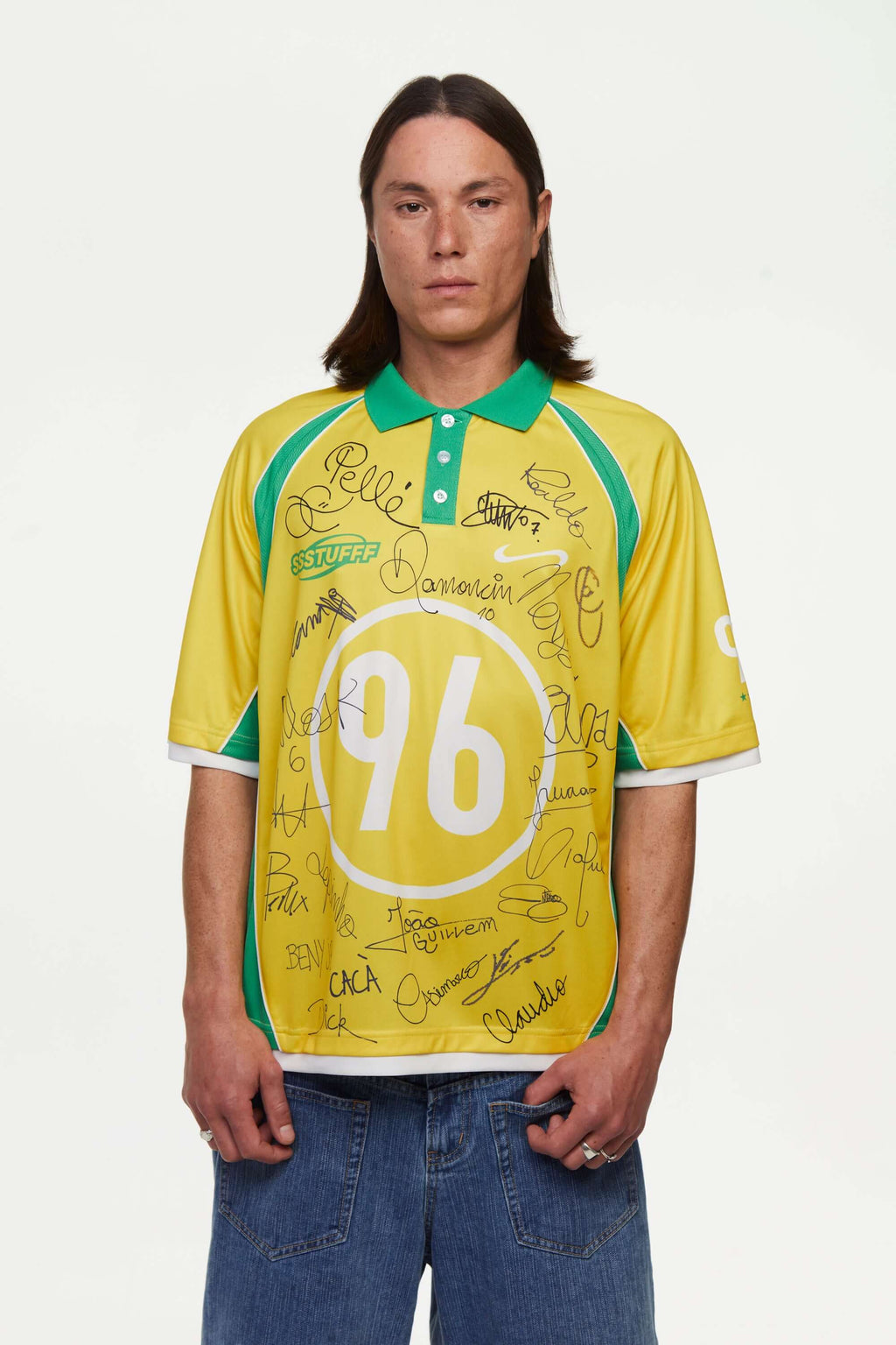 Person wearing a yellow and green sports jersey with '96' and signatures on a white background