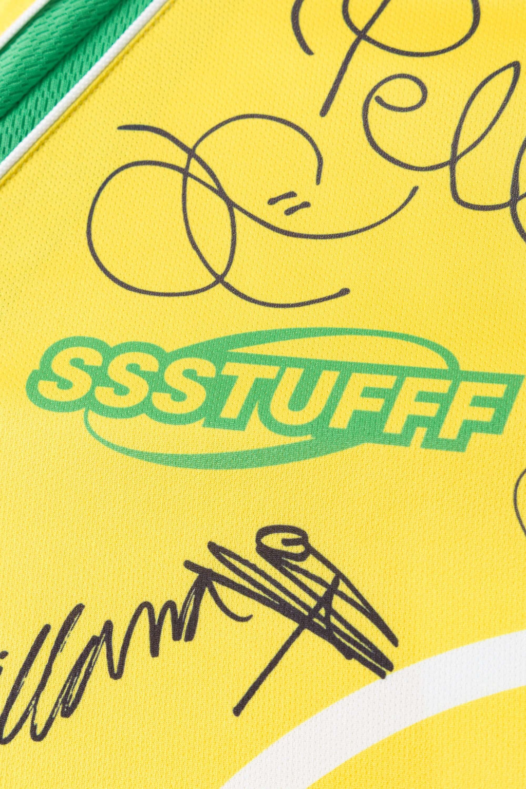 Close-up of a yellow product with 'SSSTUFF' branding and signature text.