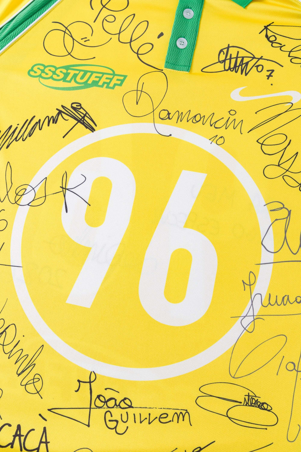 Close-up of a yellow and green sports jersey with '96' and signatures