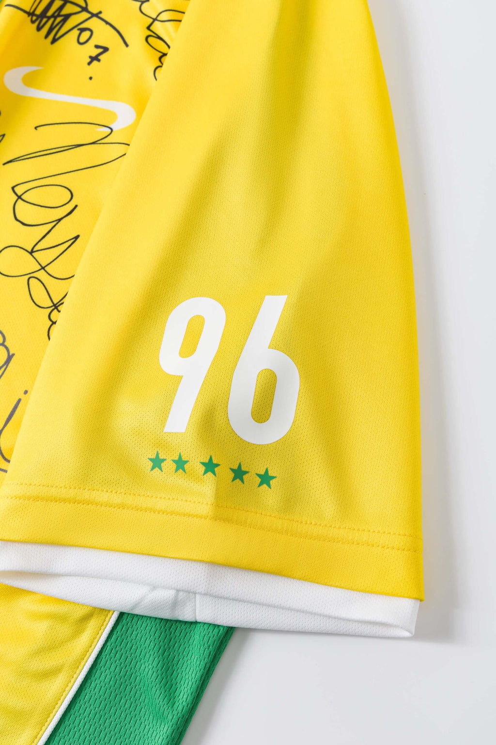 Yellow sports jersey with number 96 and green accents on a white background