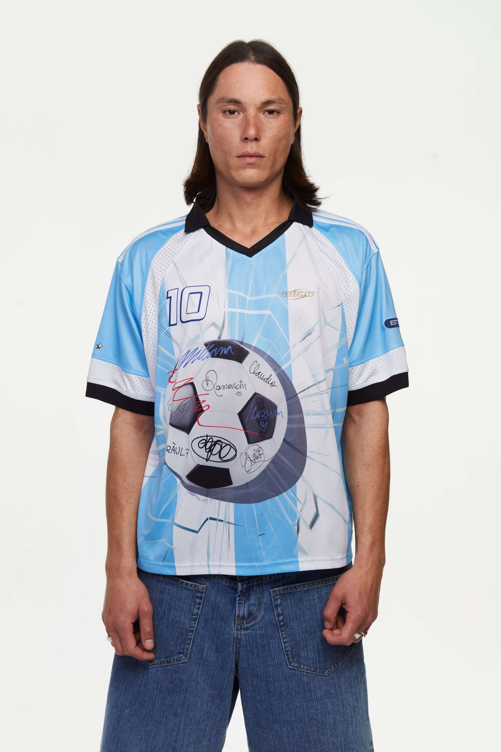 Person wearing a blue and white sports jersey with a soccer ball design signed with a number '10' and brand logo on a plain background
