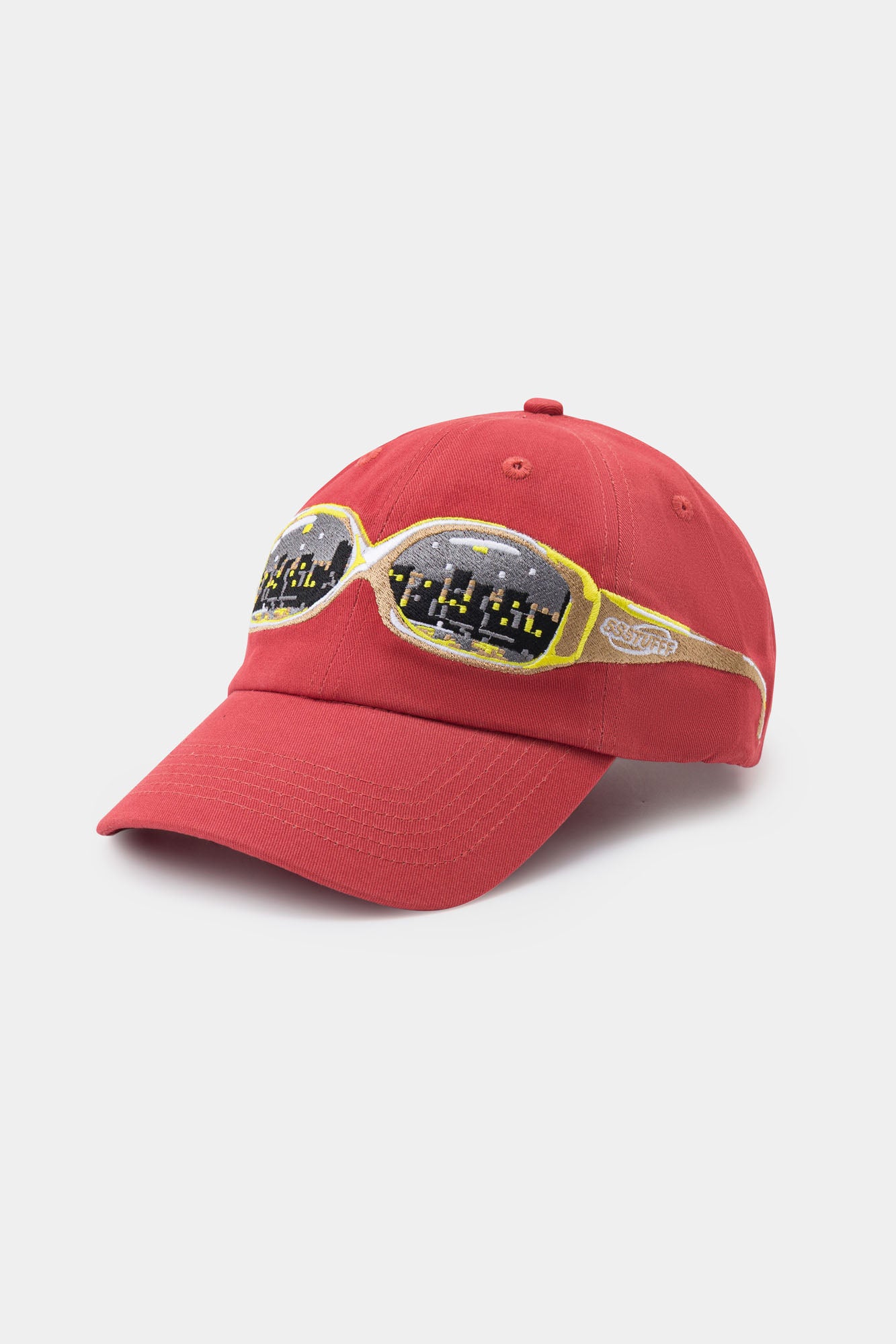 Red cap with a embroidery glasses on it, seeing a city on them.