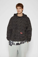 Leopard print zip up with a red label on a light gray background