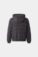 Leopard print zip up with a red label on a light gray background