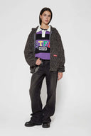 Leopard print zip up with a red label on a light gray background