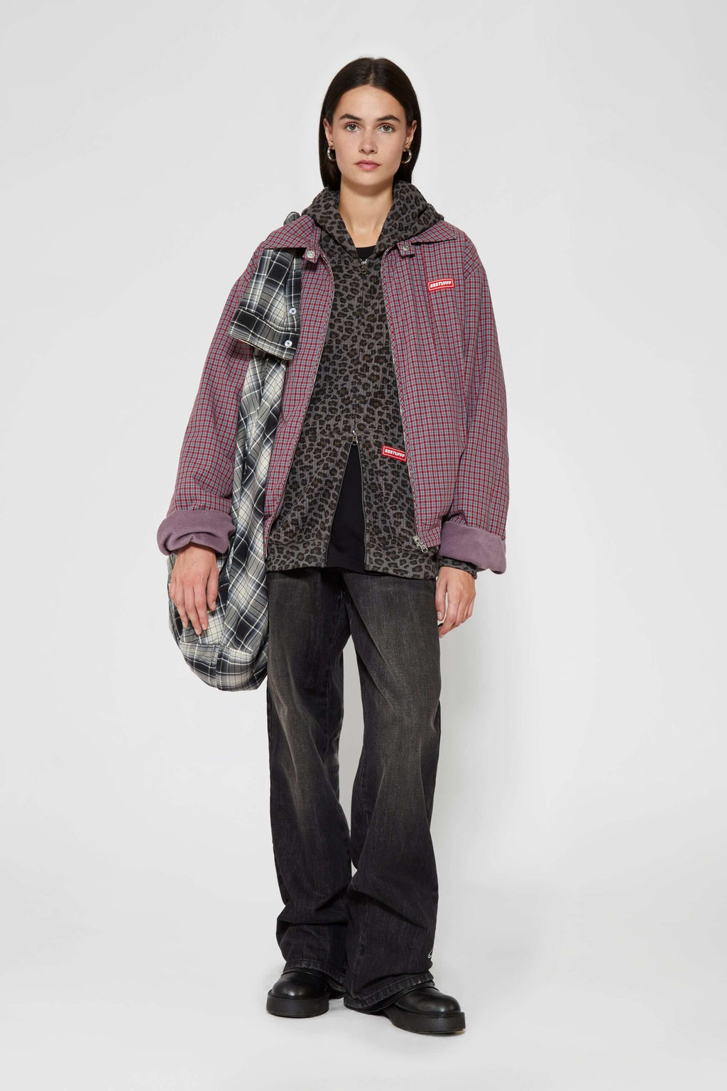 Leopard print zip up with a red label on a light gray background