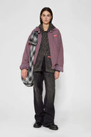 Leopard print zip up with a red label on a light gray background