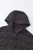 Leopard print zip up with a red label on a light gray background