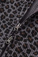 Leopard print zip up with a red label on a light gray background