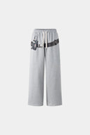 Gray wide-leg pants with a walkman belt on a grey background