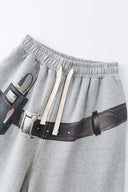 Gray wide-leg pants with a walkman belt on a grey background