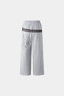 Gray wide-leg pants with a walkman belt on a grey background