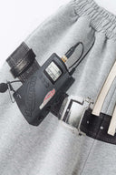 Gray wide-leg pants with a walkman belt on a grey background