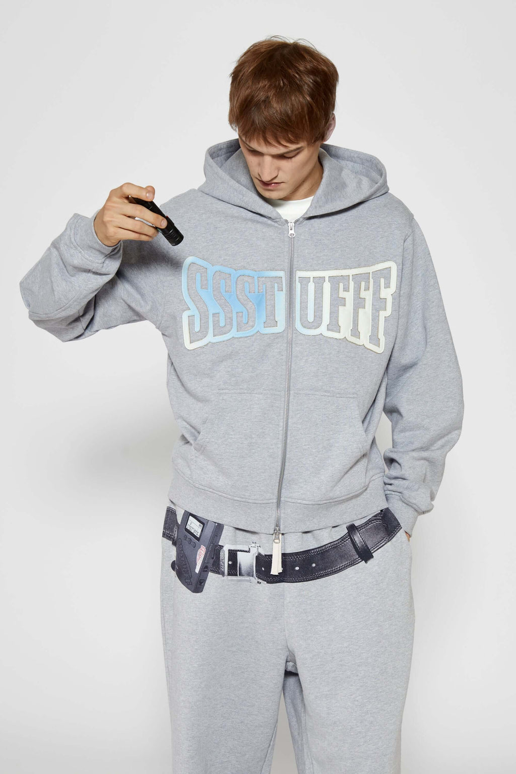 Gray hoodie with 'SSSTUFF' that changed color with UV light