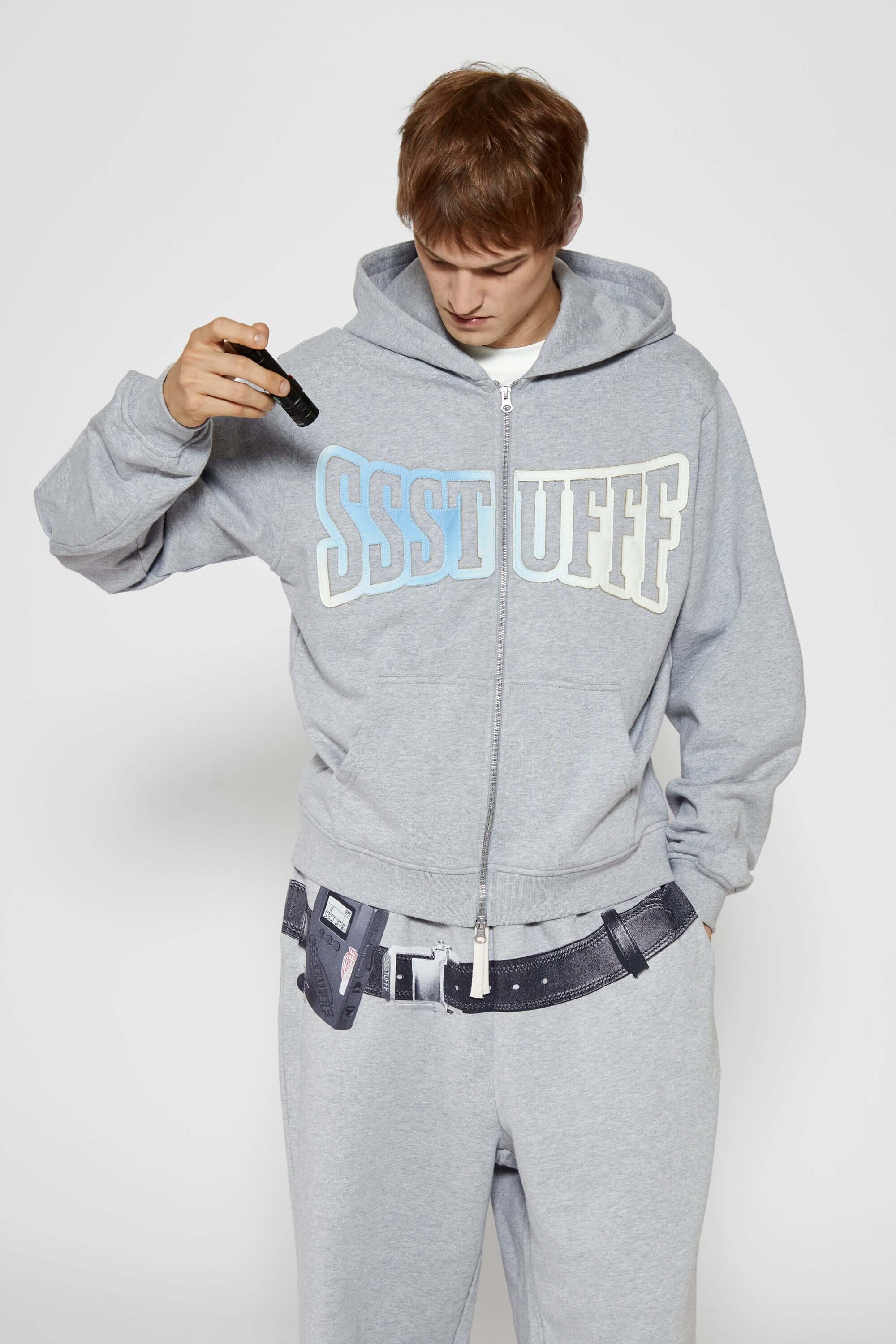 Gray hoodie with 'SSSTUFF' that changed color with UV light