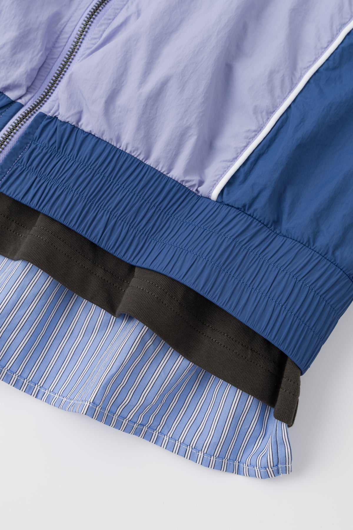 Detail of the elasticated hem over the striped shirting lining.