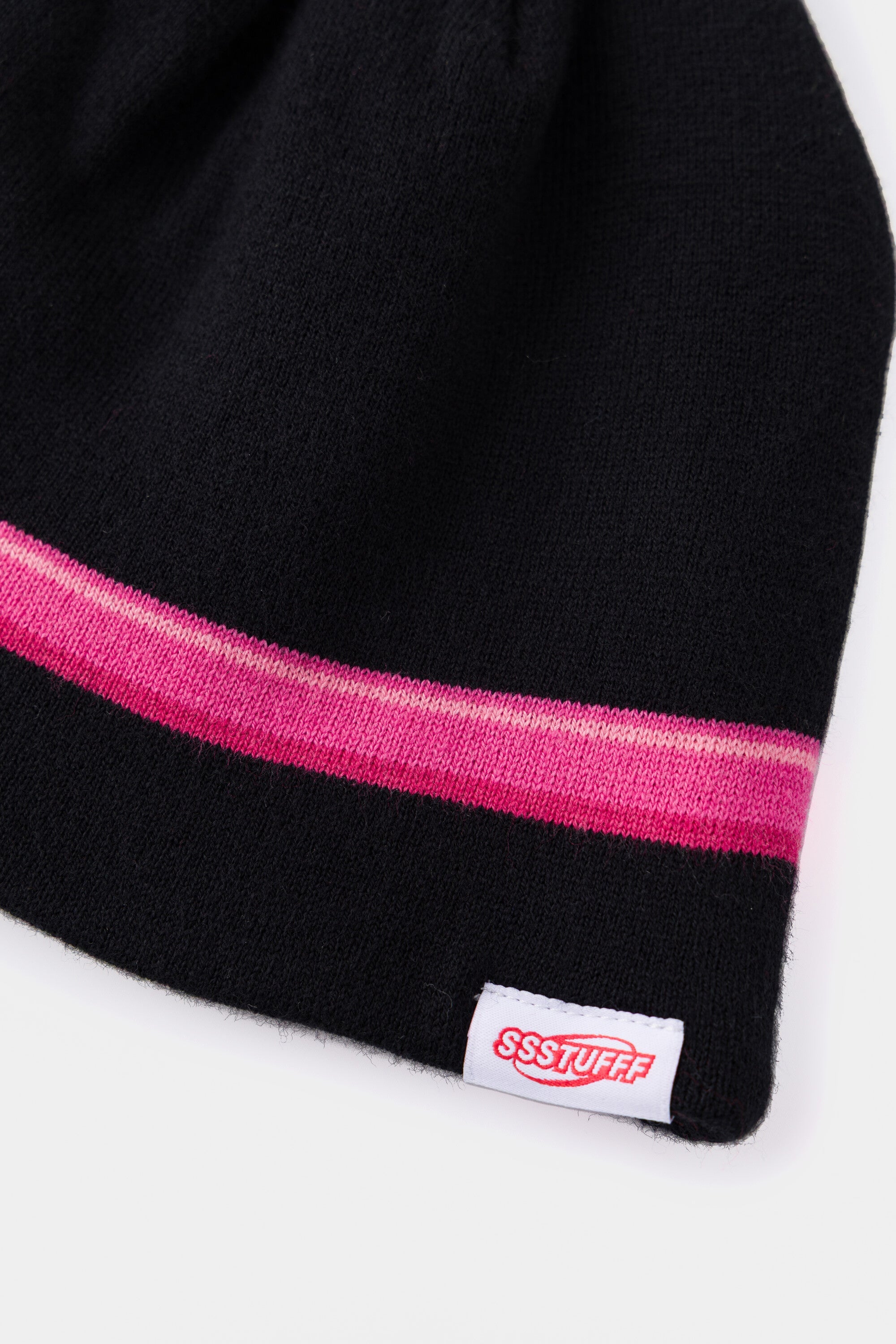 Detail of the pink bow tape running round the beanie, above the red Ssstufff label.