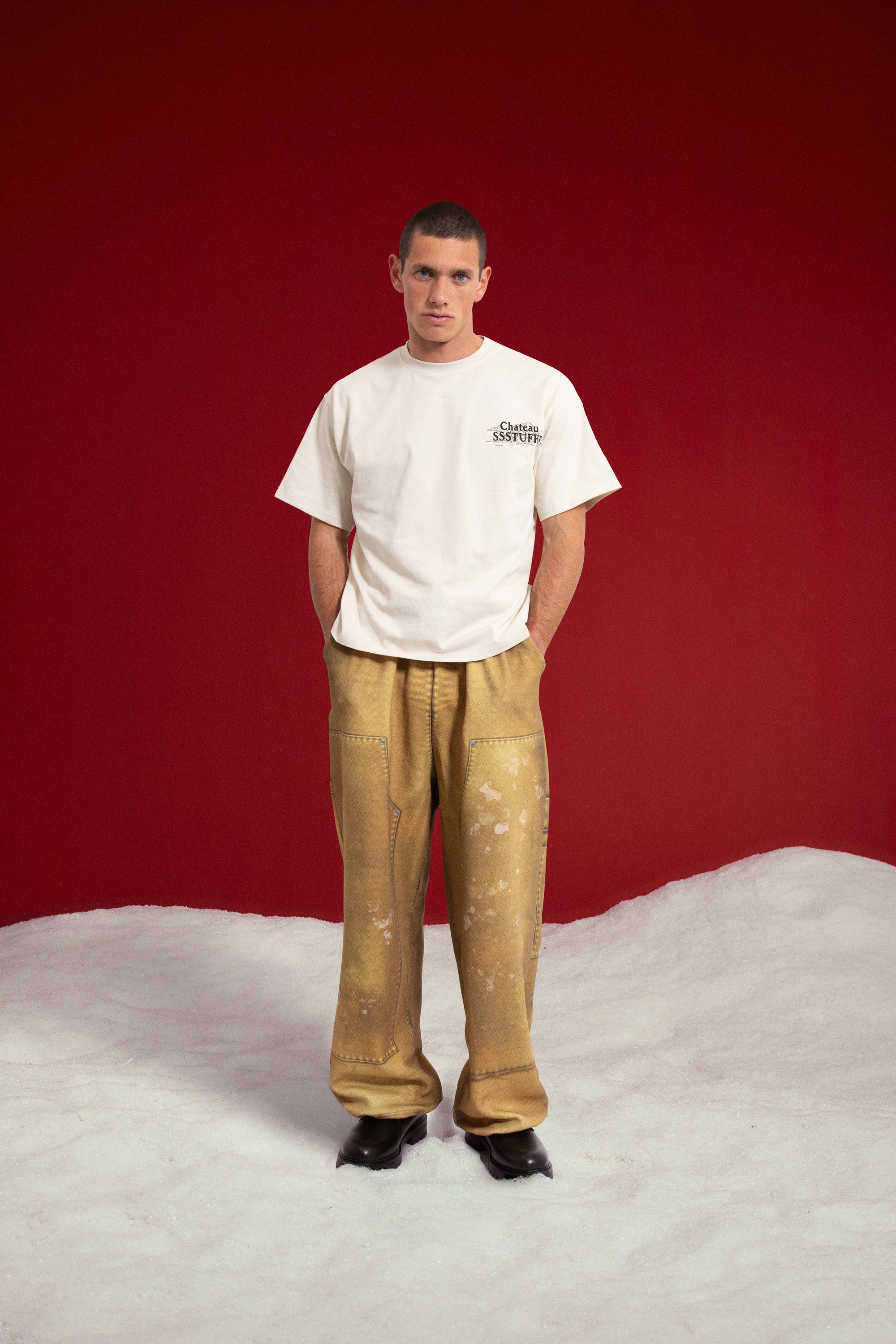 Model wearing the Chateau SSSTUFFF UV Clues Tee with the small chest logo.