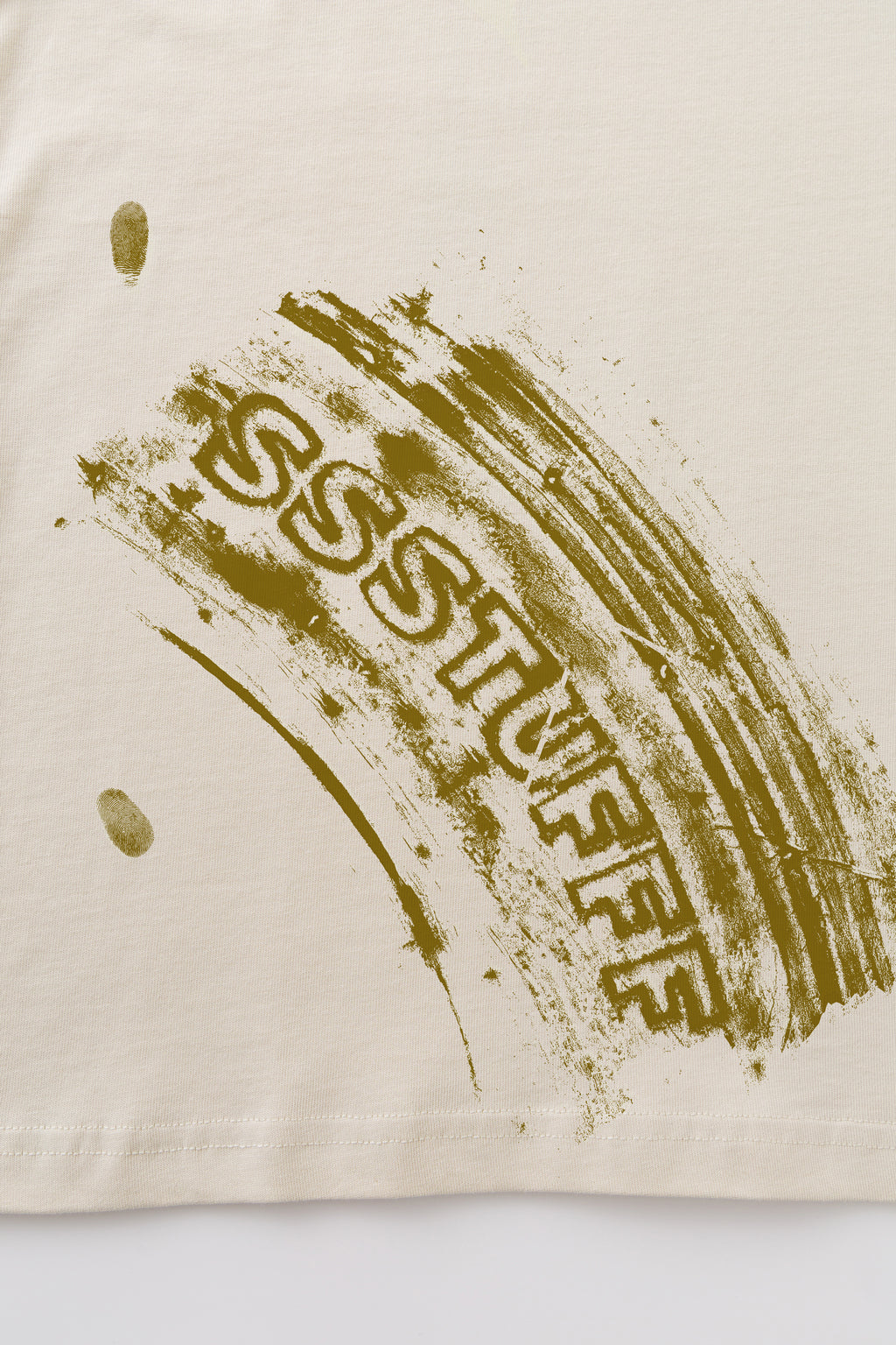 Close-up of the UV-reactive olive tyre track with SSSTUFFF lettering across it.