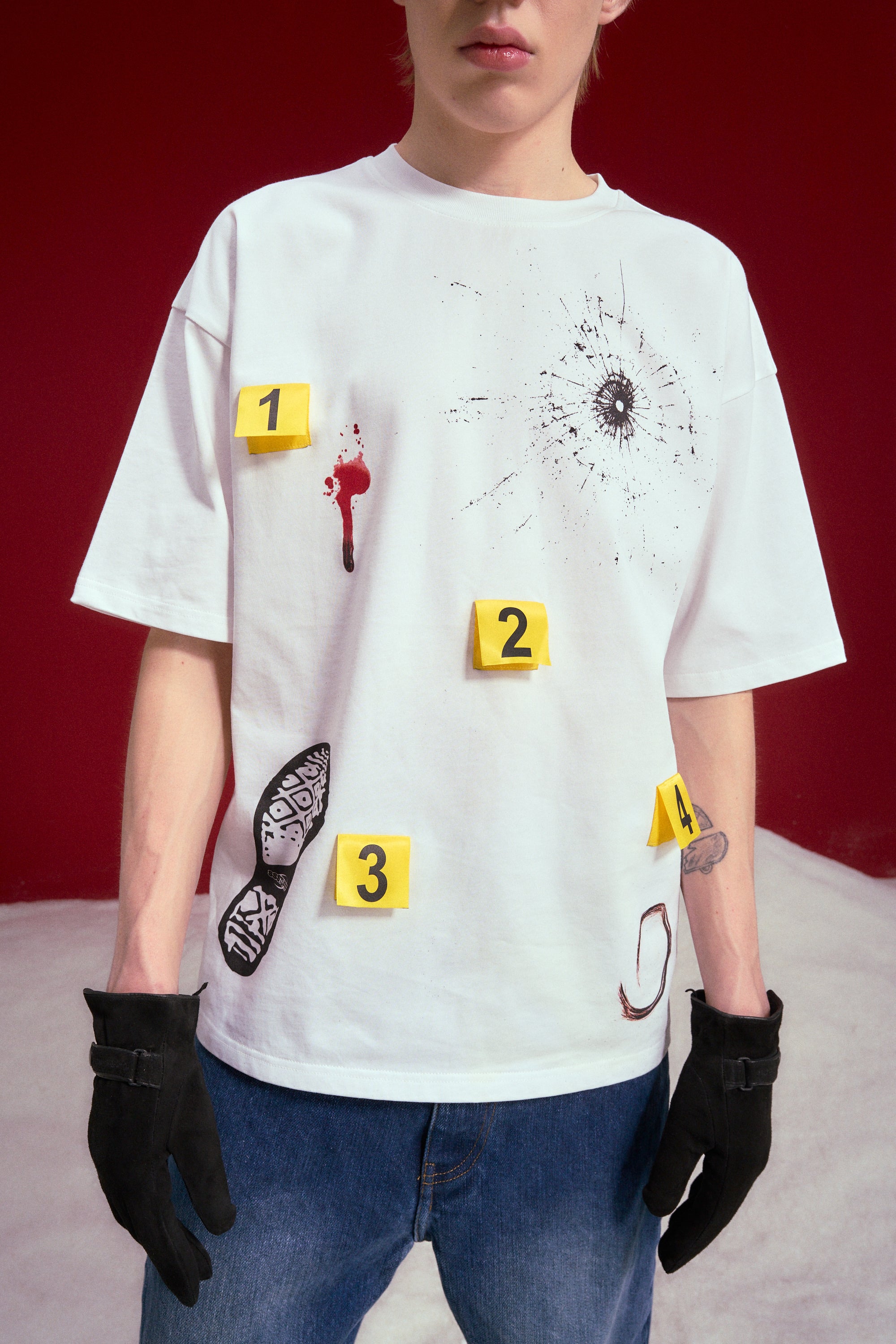Model wearing the Crime Scene Tee with black gloves and jeans.