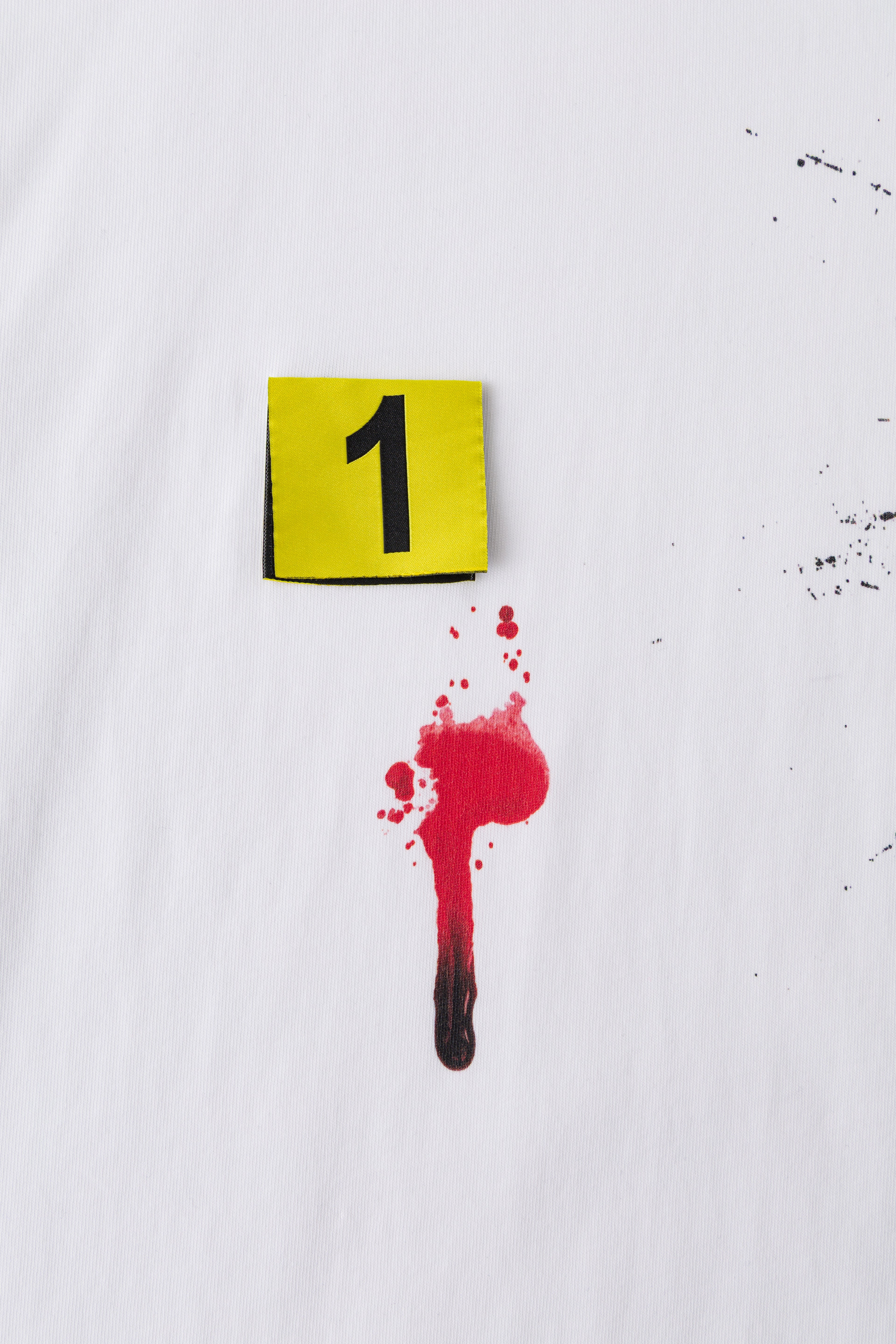 Close-up of evidence marker 1 beside the red blood drip print.
