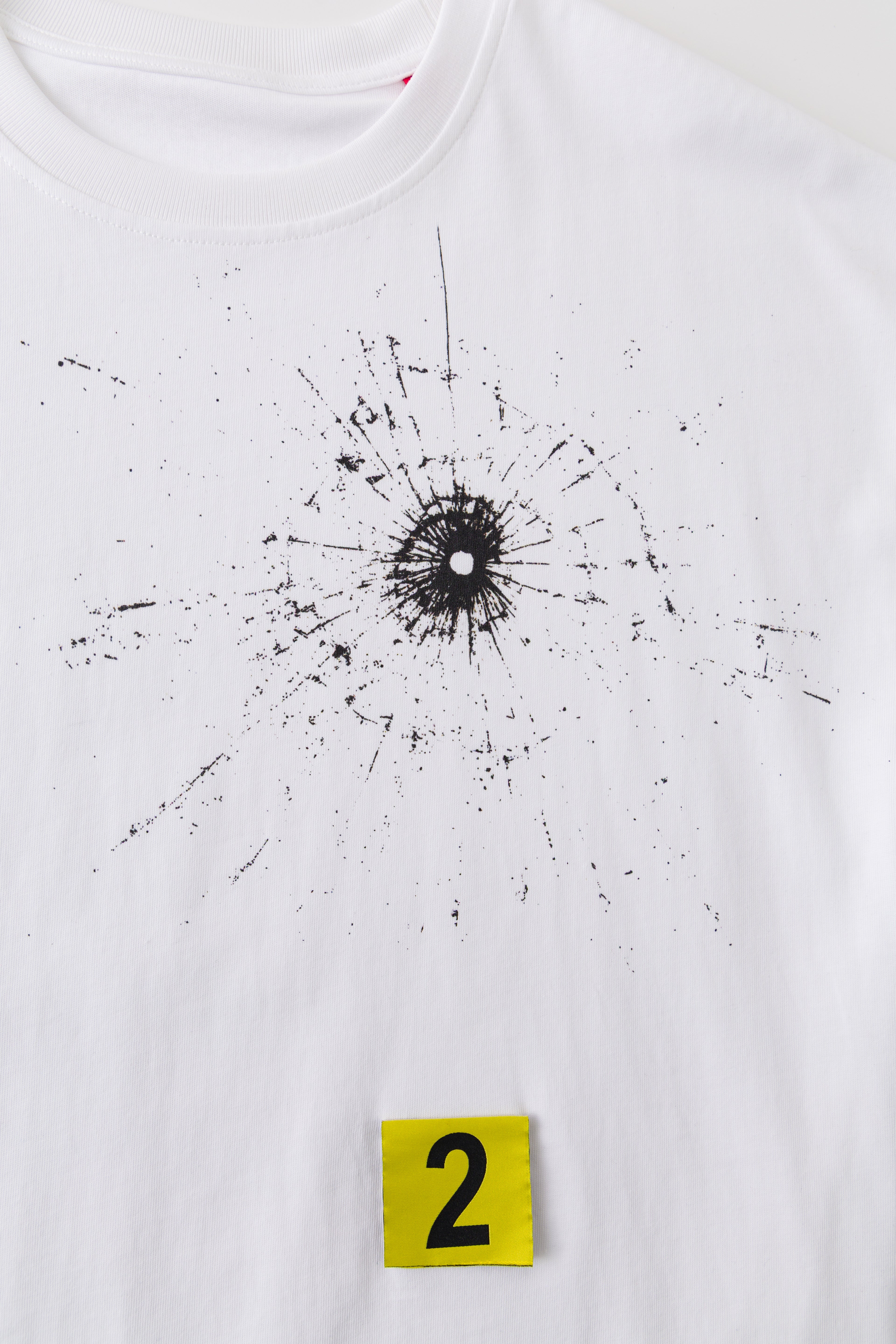 Close-up of the bullet hole and its splatter print under marker 2.