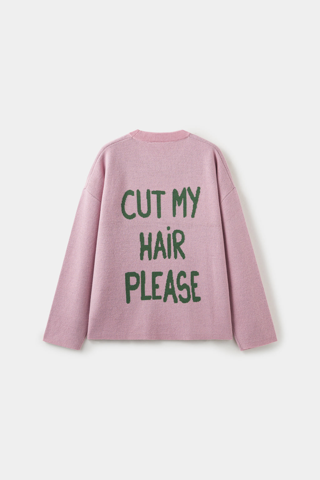 Back view of the pink knit, with CUT MY HAIR PLEASE knitted across the back in green.