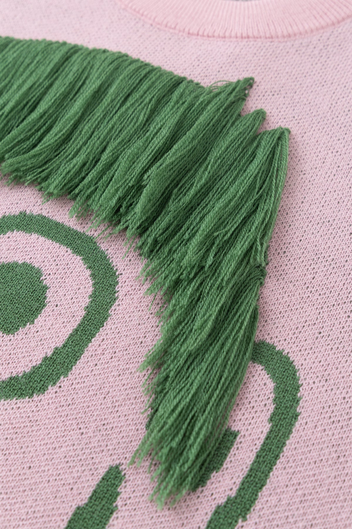 Detail of the hand-knotted green fringe, ready to be cut into any style.