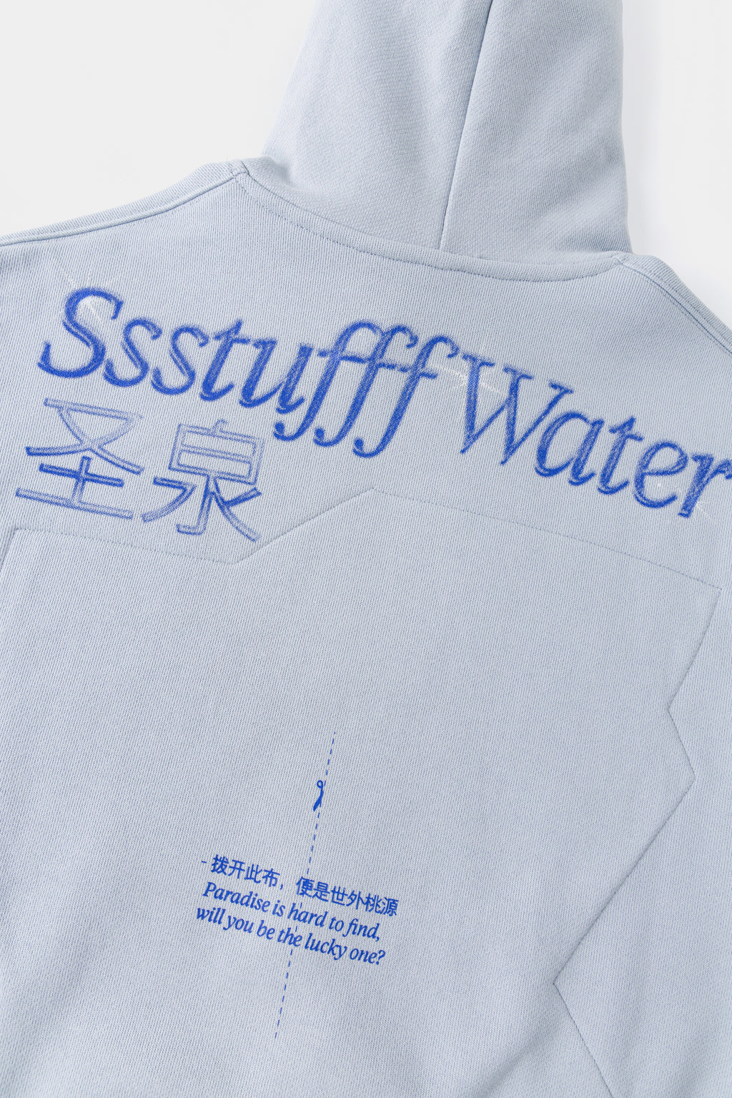 Detail of the back print, with the line Paradise is hard to find under the logo.