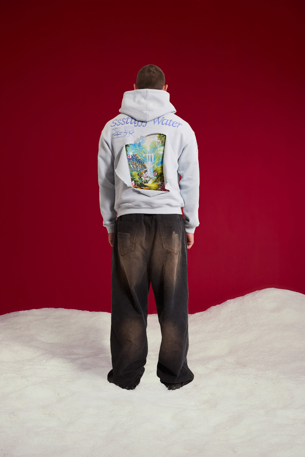Cut & Reveal Water Hoodie in pale blue, printed with the Ssstufff Water logo at the chest. Worn on a model, full-length back view showing the Ssstufff Water back print.