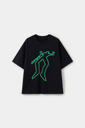 The same tee in the dark, with the chalk outline glowing green.