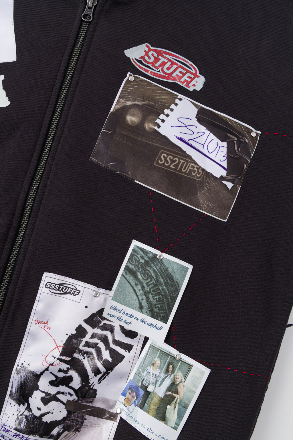 Detail of the front zip running through the printed evidence tags.
