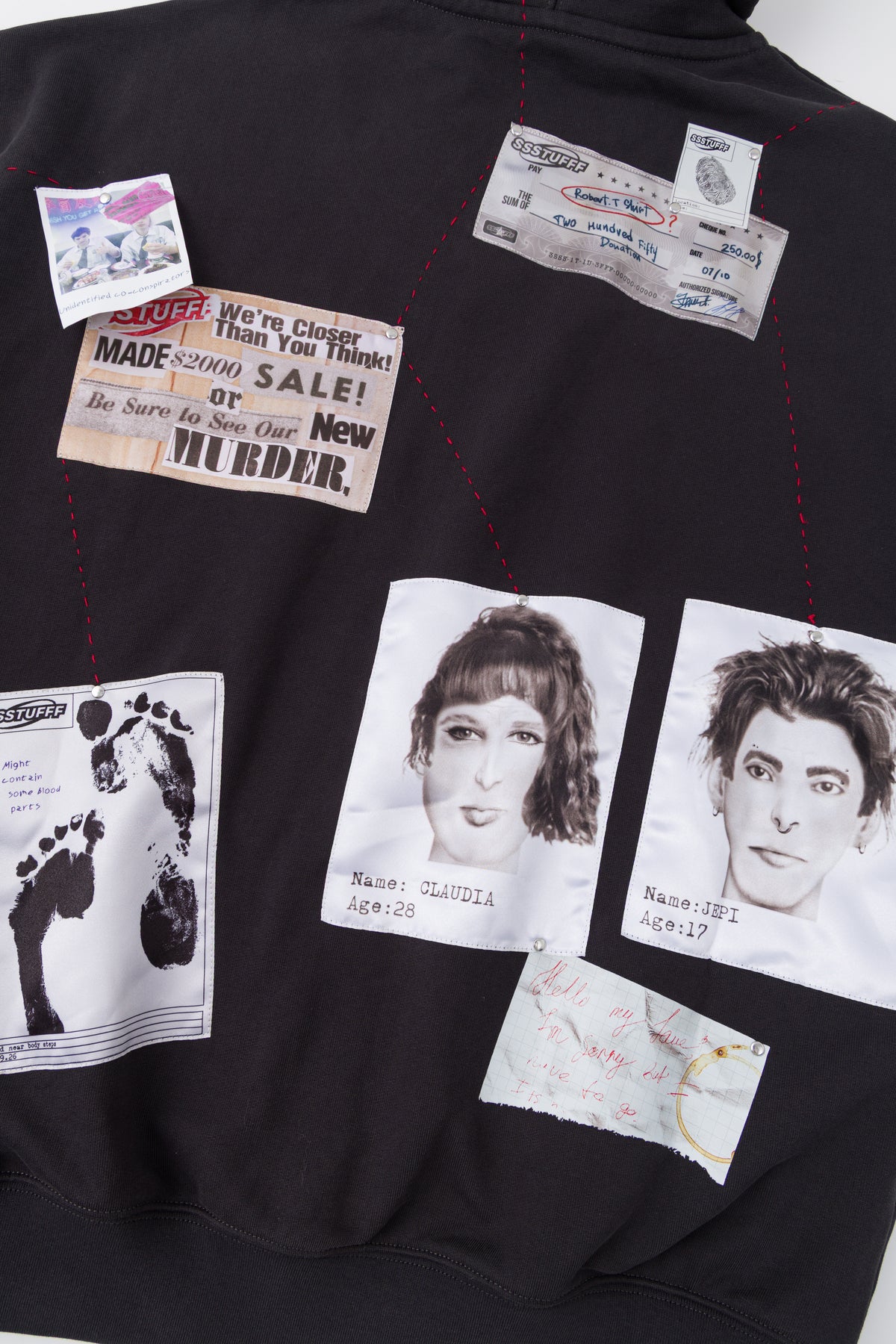 Close-up of the newspaper clipping and portraits on the back.
