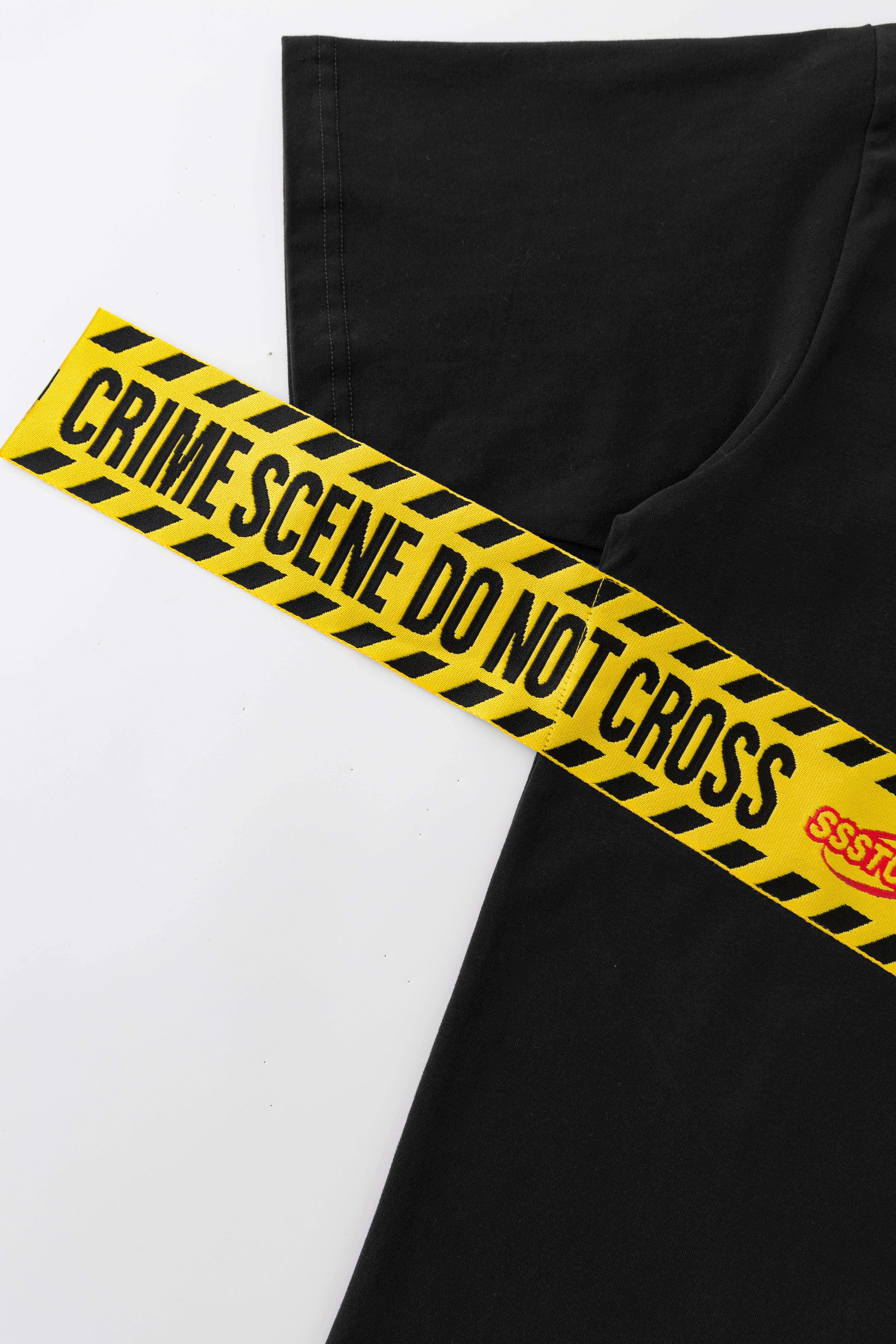 Detail of the woven yellow CRIME SCENE DO NOT CROSS tape with SSSTUFFF lettering.