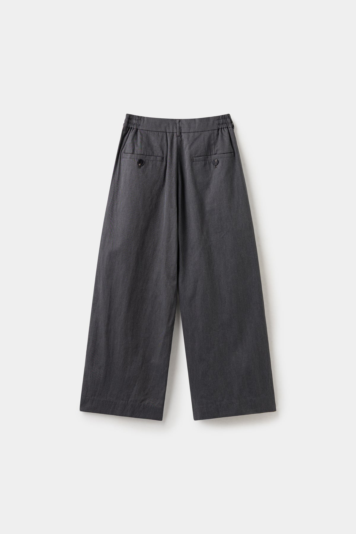 Back view of the black wide leg dress pants, with a buttoned welt pocket.