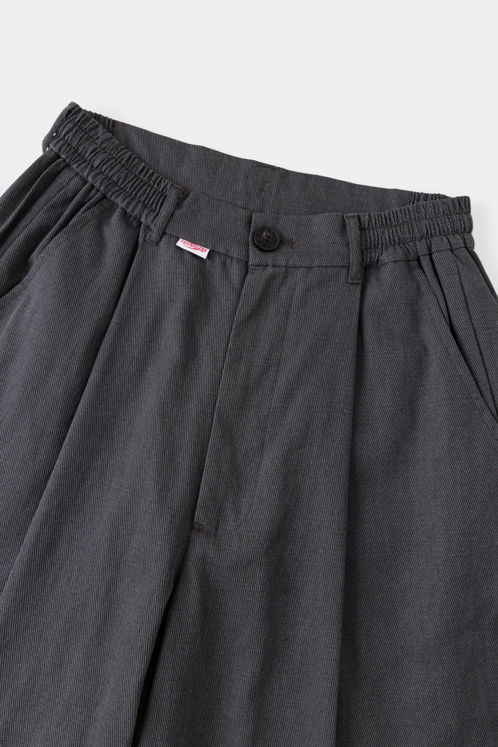 Close-up of the elasticated waistband, front pleats and red Ssstufff tab.