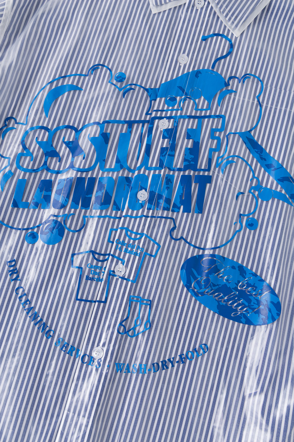 Detail of the blue SSSTUFFF LAUNDROMAT print on the garment bag.