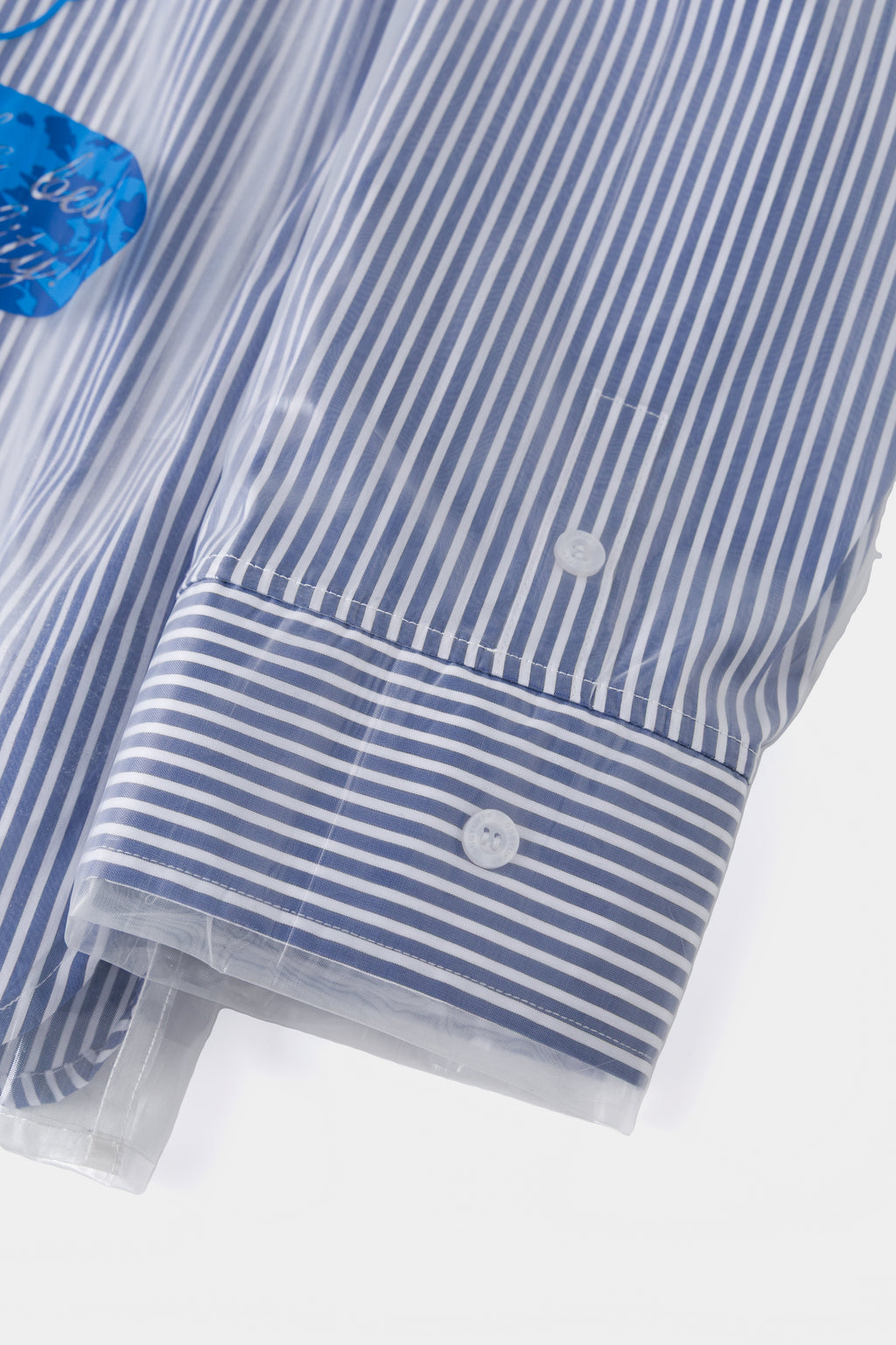 Close-up of the buttoned cuff under the clear cover.