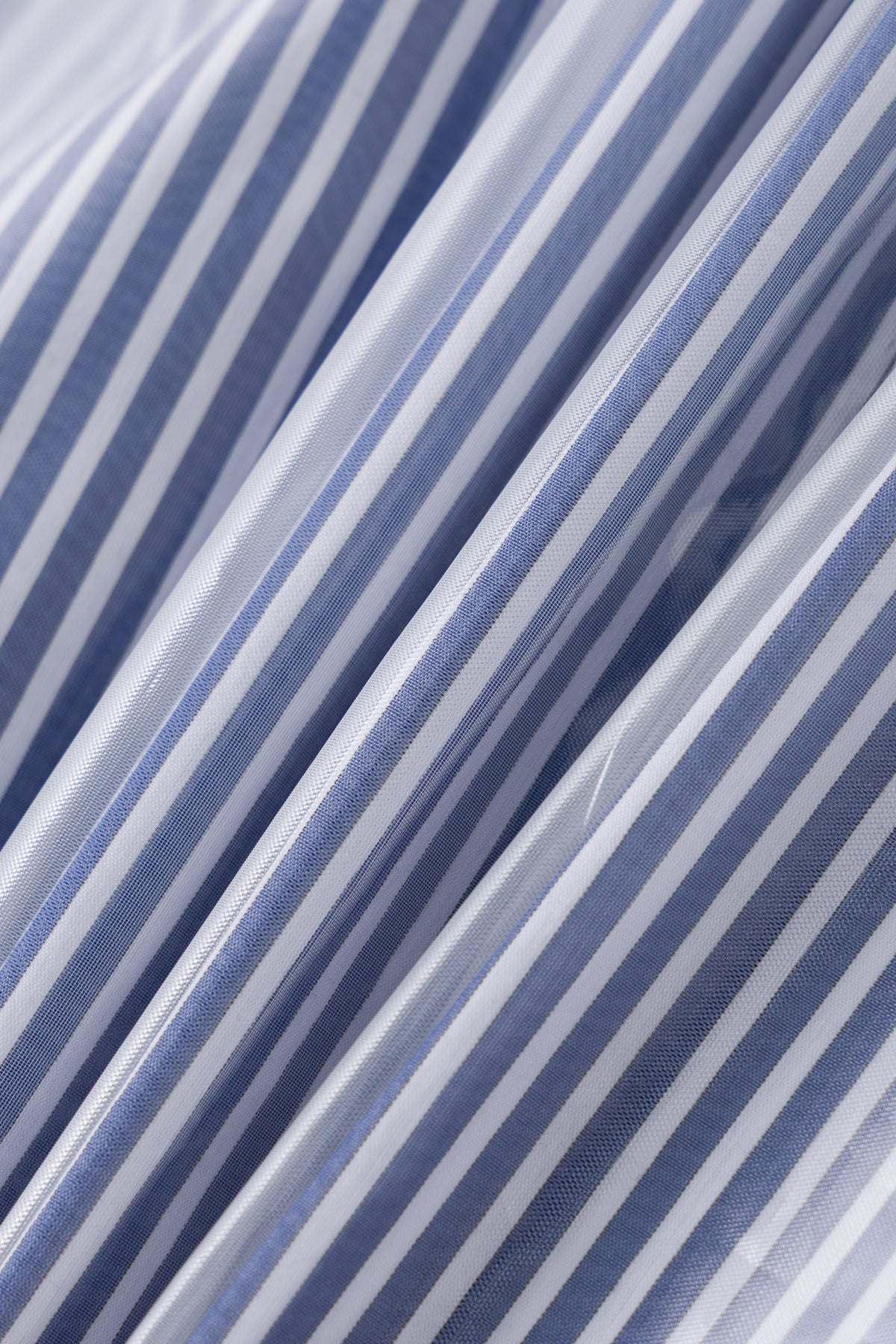 Blue striped cotton shirting under the clear cover, fabric detail.