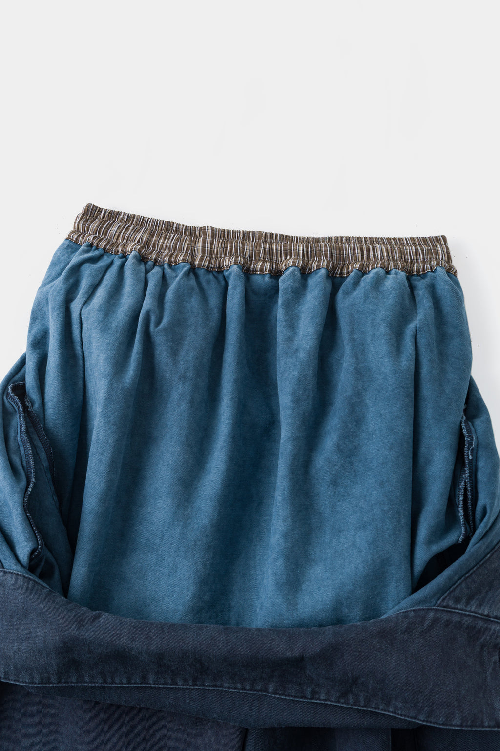 Close-up of the back waistband and the light blue inside of the folded bib.