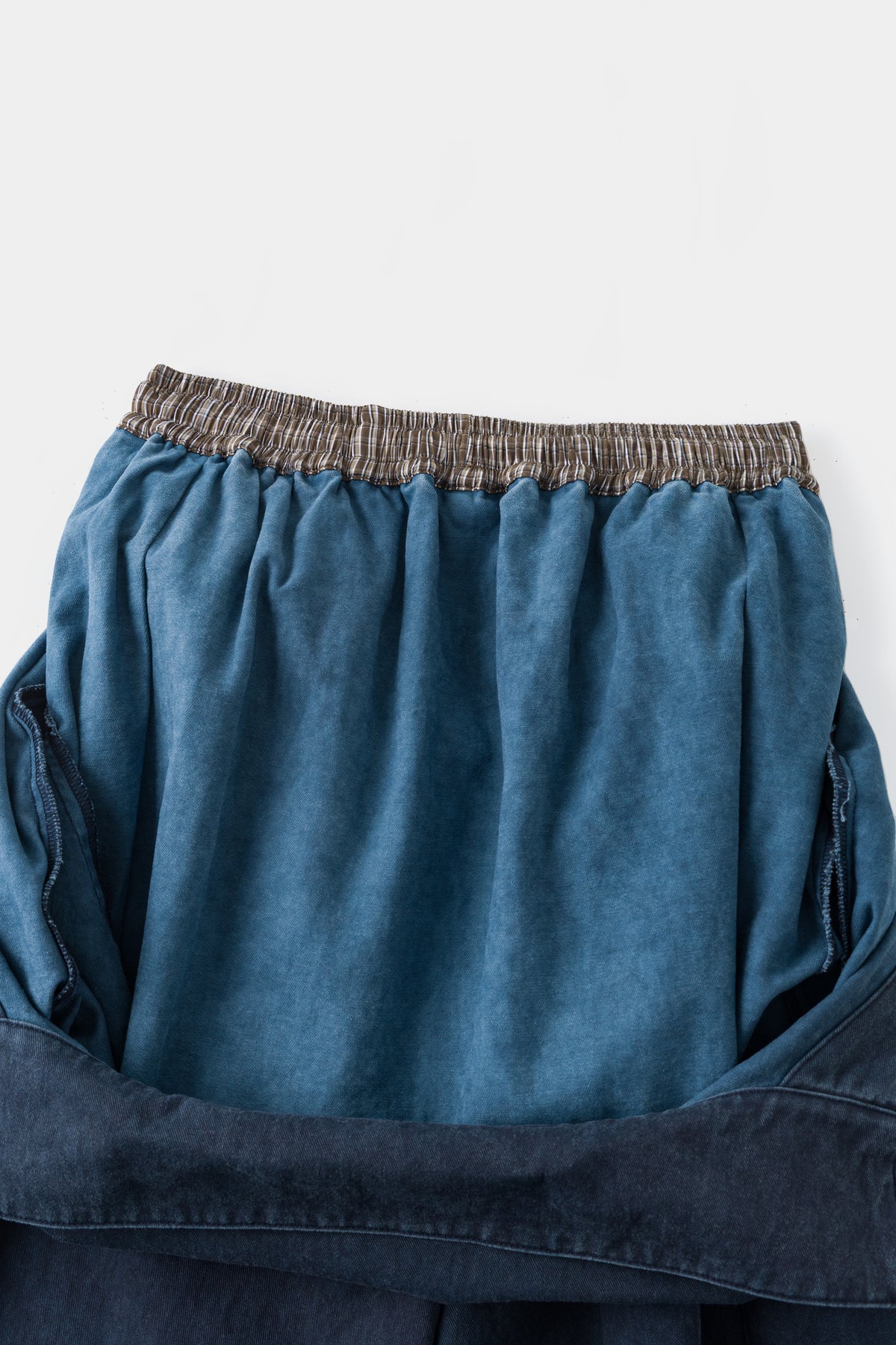 Close-up of the back waistband and the light blue inside of the folded bib.