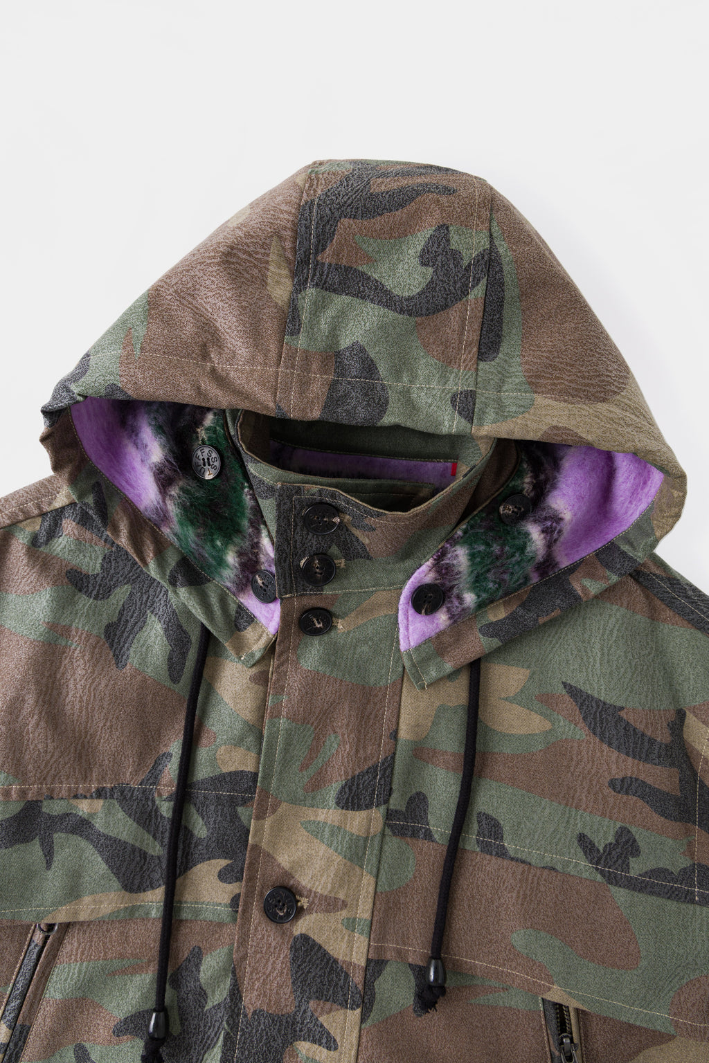 The hood up, with the purple faux fur lining showing at the opening.