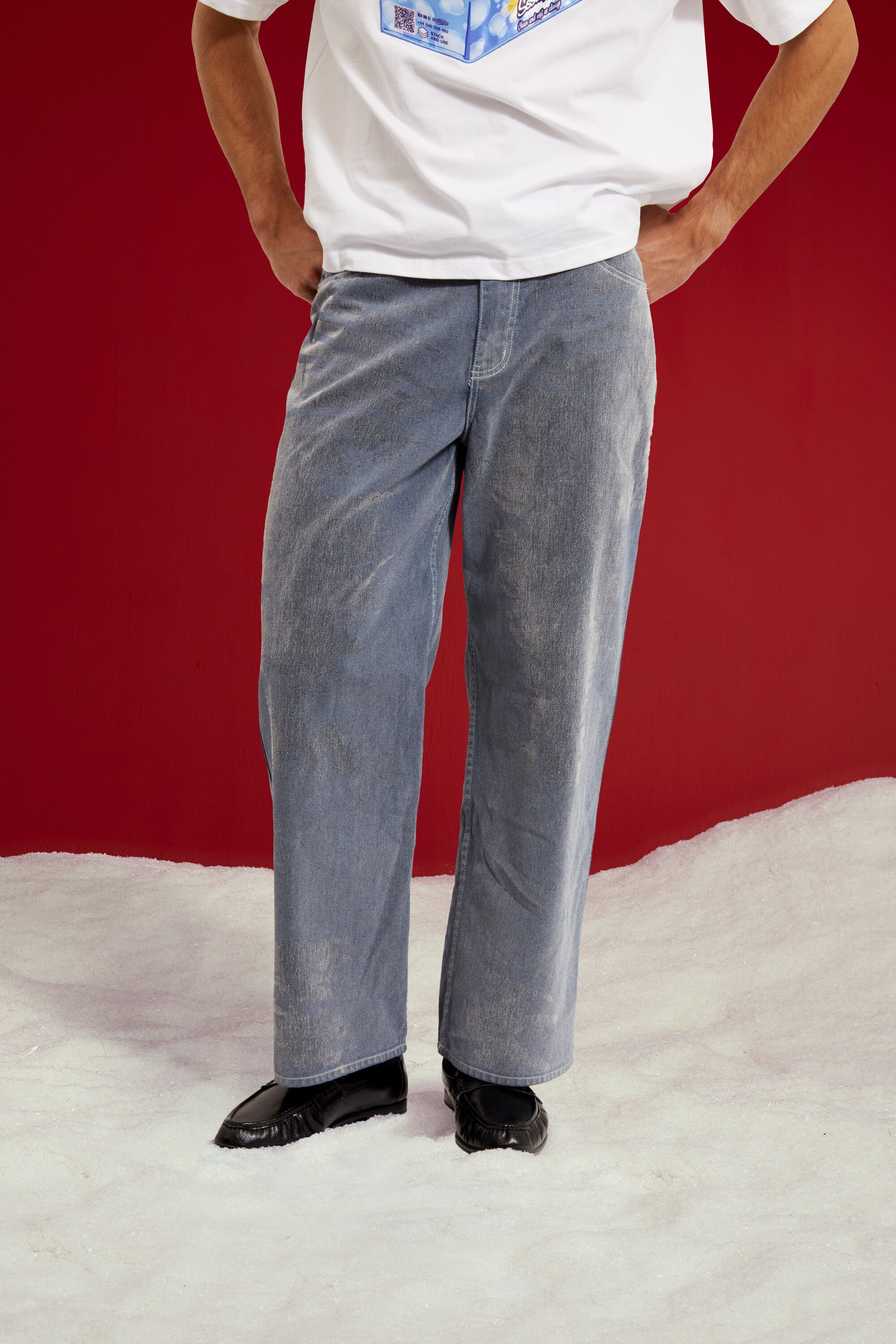 Flock Denim in washed light blue, a flocked wide leg jean. Worn on a model, close-up detail, front.