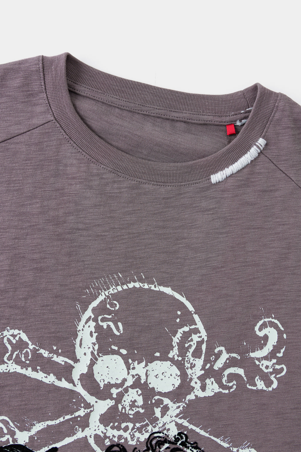 Close-up of the neckline above the flocked skull print.
