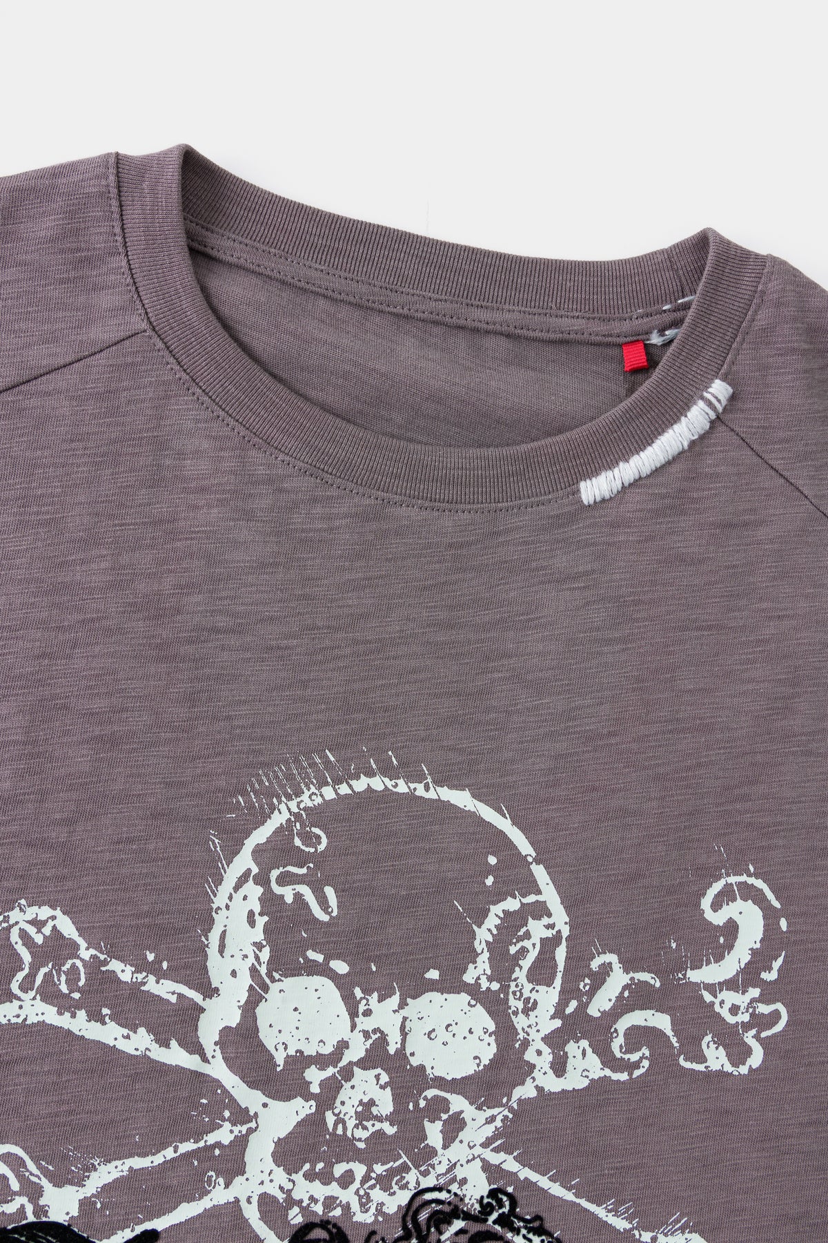 Close-up of the neckline above the flocked skull print.
