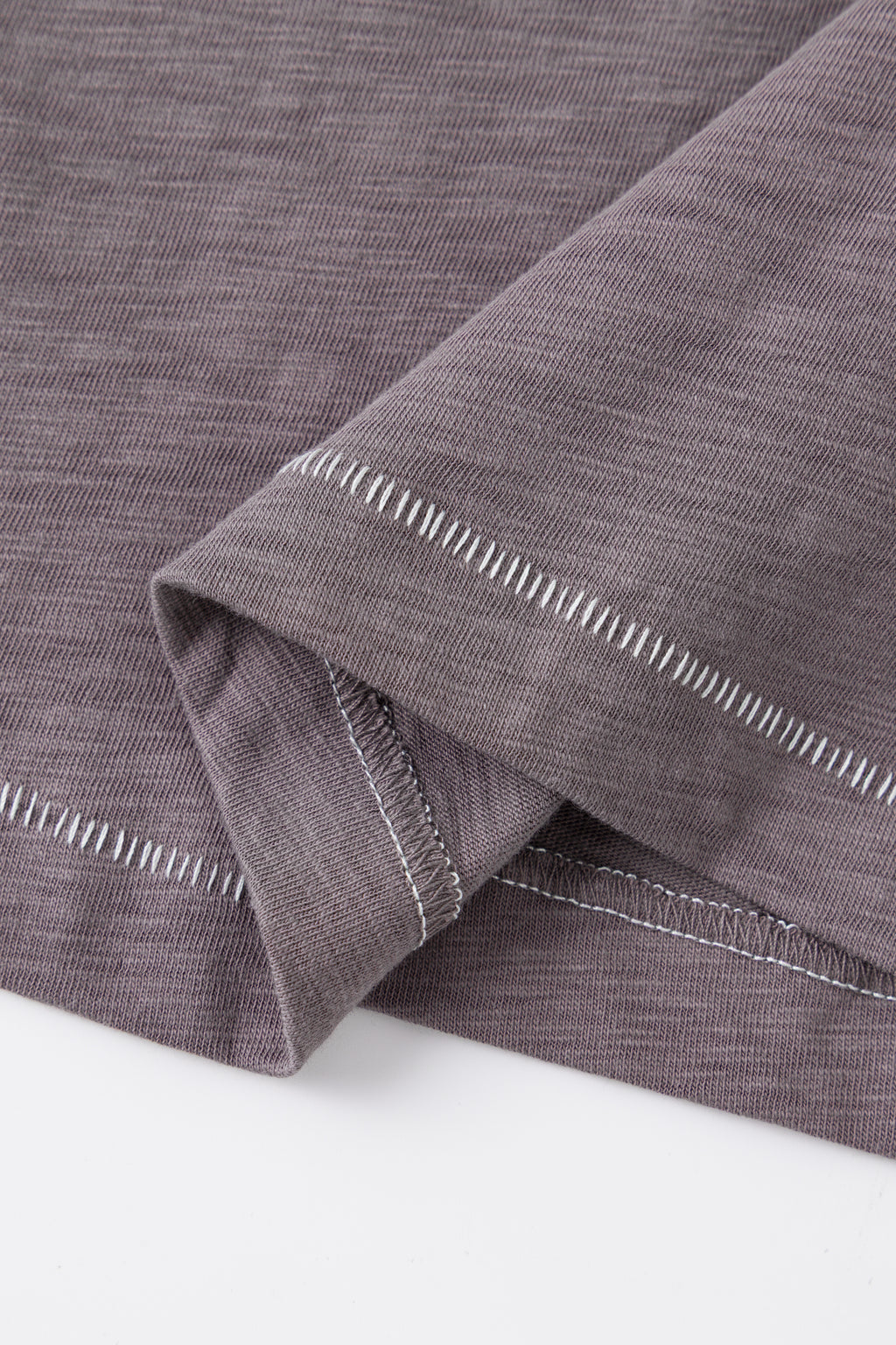 Close-up of the contrast topstitched hem.