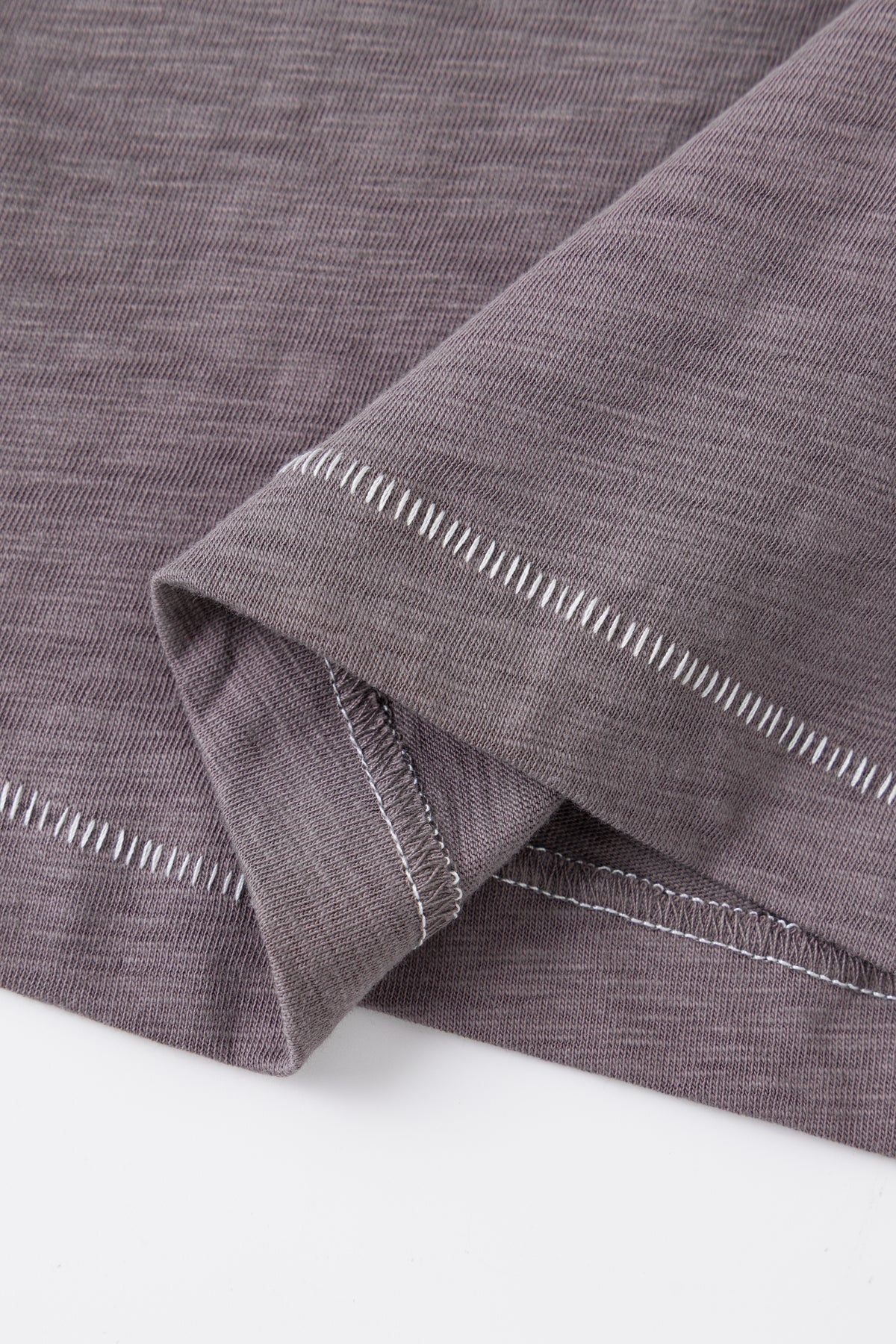 Close-up of the contrast topstitched hem.