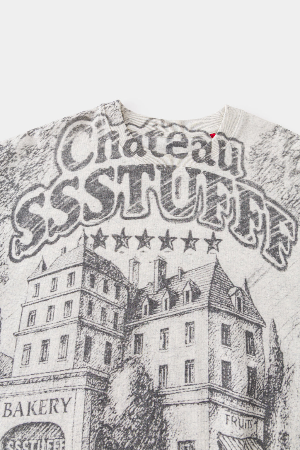 Close-up of the chest print: Château SSSTUFFF lettering with five stars above the sketched hotel.
