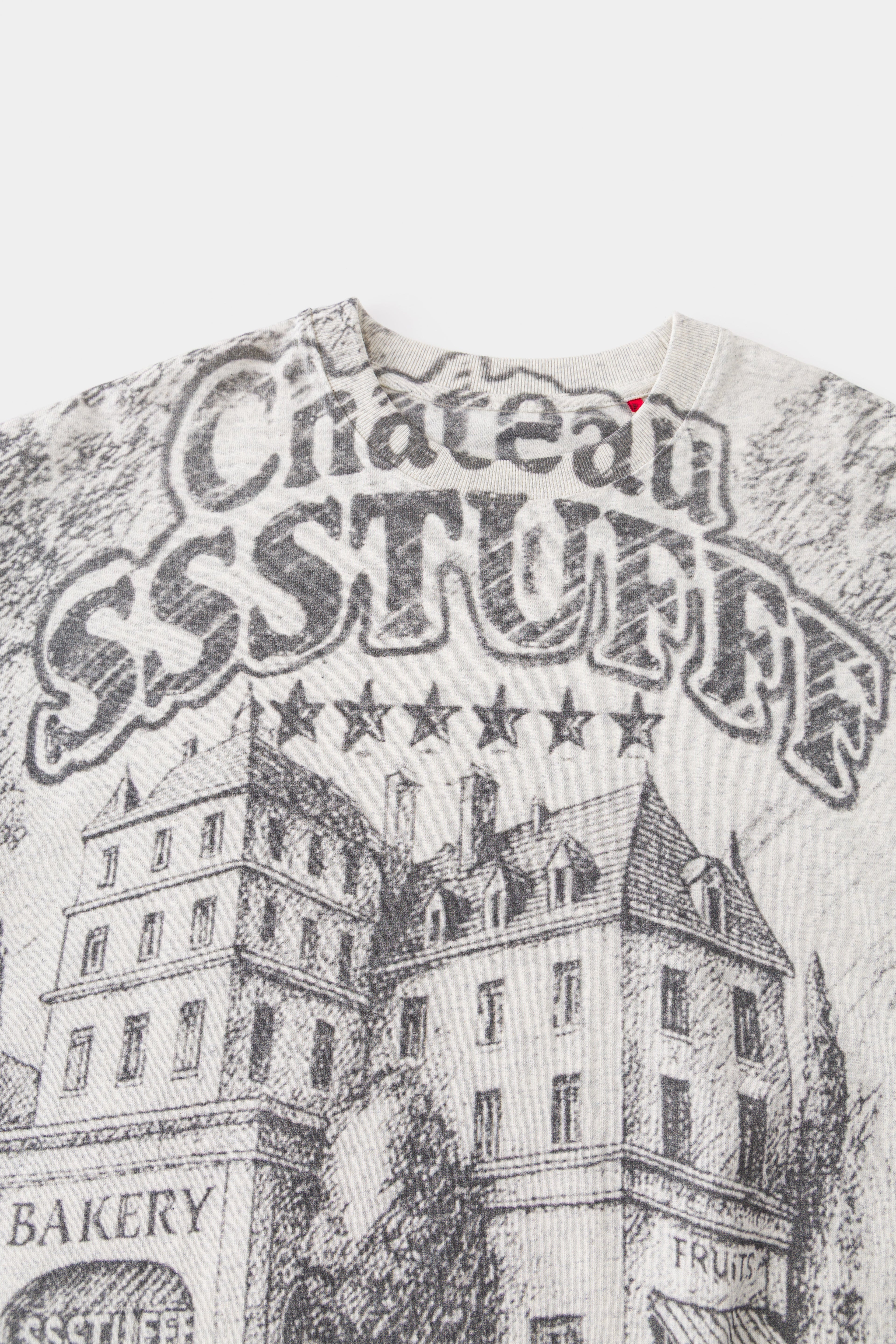 Close-up of the chest print: Château SSSTUFFF lettering with five stars above the sketched hotel.
