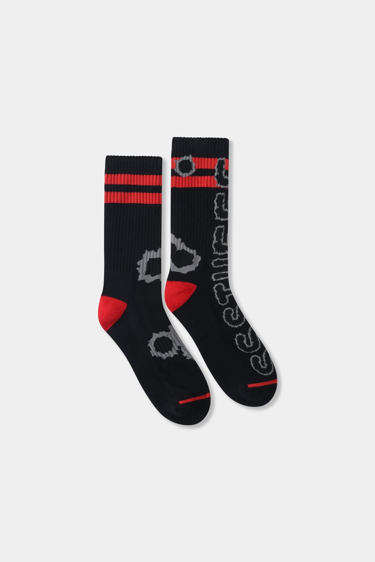 Gunshots Socks in black, ribbed crew socks with red stripes, red heels and toes, and grey bullet-hole jacquard down the leg.
